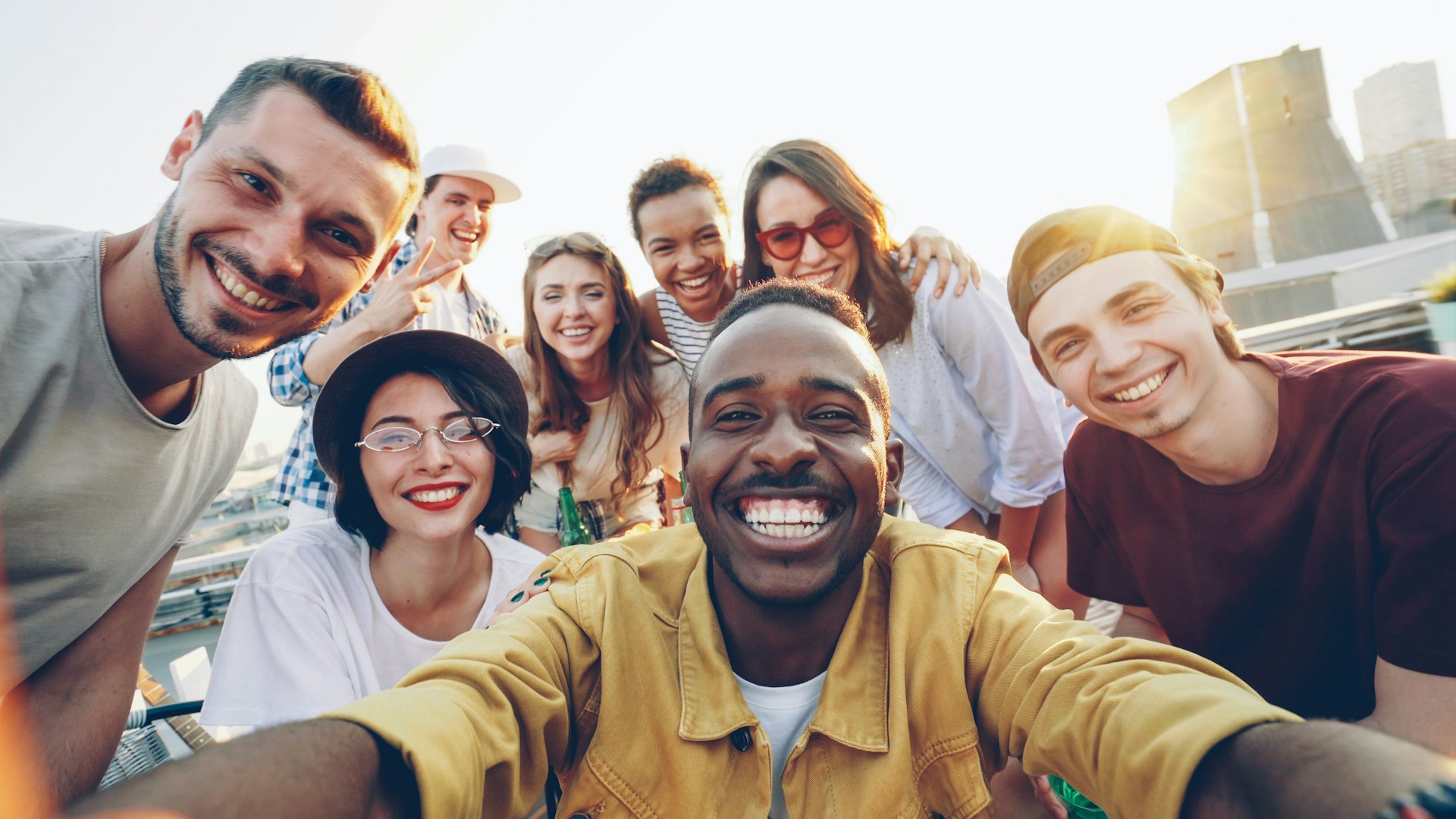 A diverse group of friends smiling and laughing together outdoors